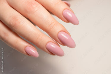 Nude manicure. Gel nail polish in light pink color. Almond shaped nails. Beautiful manicure.
