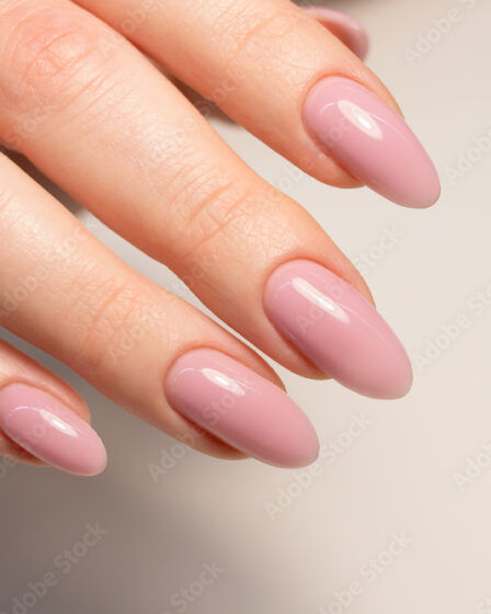 Nude manicure. Gel nail polish in light pink color. Almond shaped nails. Beautiful manicure.